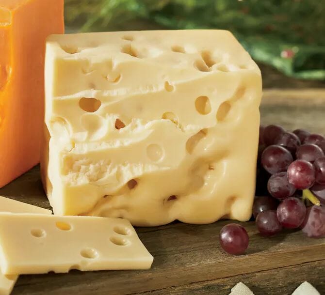 A square block of baby swiss cheese